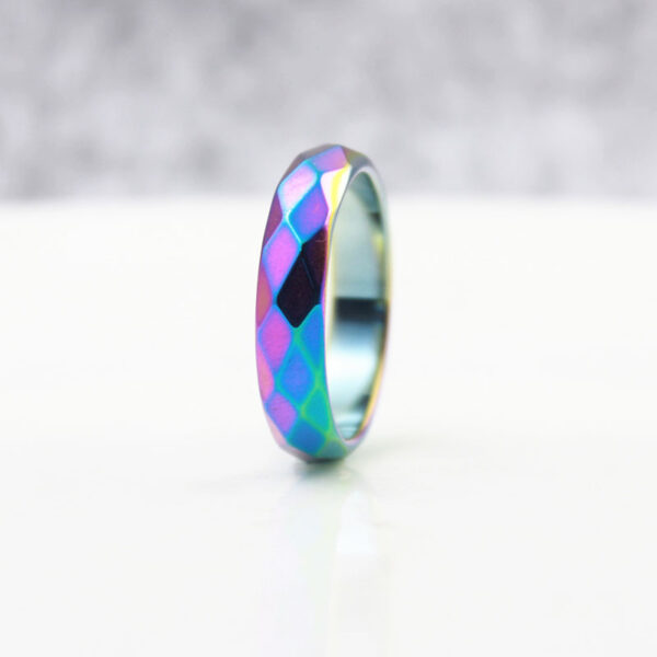 A rainbow faceted hematite ring 6mm wide